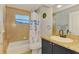 Bathroom featuring tiled walls, granite countertops, and classic fixtures at 1563 Arundel Ave, North Port, FL 34288