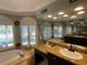 Bright bathroom featuring a soaking tub with shuttered windows and granite countertops at 1563 Arundel Ave, North Port, FL 34288