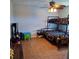 Neutral bedroom features a bunk bed, ceiling fan, and a tile floor at 1563 Arundel Ave, North Port, FL 34288