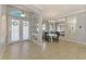 Elegant dining area with chandelier and mirrored walls is open to the foyer at 1563 Arundel Ave, North Port, FL 34288