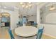 Open dining room with chandelier and views into the living room and entryway at 1563 Arundel Ave, North Port, FL 34288