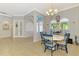 Bright dining area with tile flooring and chandelier lighting at 1563 Arundel Ave, North Port, FL 34288