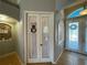 Welcoming entryway with decorative door and sidelight, offering a bright introduction to the home's interior at 1563 Arundel Ave, North Port, FL 34288