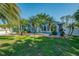 Charming home with bright blue exterior, lush landscaping, and inviting curb appeal at 1563 Arundel Ave, North Port, FL 34288