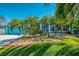 Striking blue home with well-manicured lawn and elegant palm trees enhancing the curb appeal at 1563 Arundel Ave, North Port, FL 34288