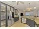 Stylish kitchen featuring a stainless steel refrigerator and granite countertops at 1563 Arundel Ave, North Port, FL 34288