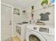 Laundry room with washer, dryer, and decorative elements at 1563 Arundel Ave, North Port, FL 34288