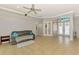 Inviting living room with neutral tones, tile floors, and an open layout leading to French doors at 1563 Arundel Ave, North Port, FL 34288