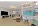 Bright living room featuring neutral tile flooring, a comfortable sofa, large windows, and stylish lighting at 1563 Arundel Ave, North Port, FL 34288