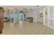 Open living area featuring tiled floors and views of the pool area at 1563 Arundel Ave, North Port, FL 34288