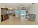 View of the open living area with tiled floors and multiple entryways at 1563 Arundel Ave, North Port, FL 34288