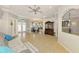 Open living room with tile floors, an antique cabinet, and views into the dining room and kitchen at 1563 Arundel Ave, North Port, FL 34288