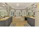Luxurious bathroom with double vanities, a soaking tub, large windows, and tile flooring at 1563 Arundel Ave, North Port, FL 34288
