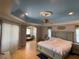 Spacious main bedroom featuring a tray ceiling, ceiling fan, and an adjacent sitting area at 1563 Arundel Ave, North Port, FL 34288