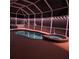 Inviting screened pool and spa area lit up at night with calming decorative lighting at 1563 Arundel Ave, North Port, FL 34288