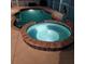Backyard pool and hot tub with a stone surround and dark coping material at 1563 Arundel Ave, North Port, FL 34288