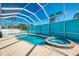 Screened-in pool and hot tub, perfect for relaxation and recreation in a private outdoor space at 1563 Arundel Ave, North Port, FL 34288