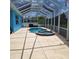 Enclosed pool and spa area, offering a private retreat with ample space for lounging and entertaining by the water at 1563 Arundel Ave, North Port, FL 34288