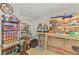 Room featuring storage shelves, a workbench, a mirror, and tiled floors at 1563 Arundel Ave, North Port, FL 34288