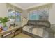 Inviting sitting room with comfortable seating, natural light, and serene pool views at 1563 Arundel Ave, North Port, FL 34288
