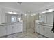 Large bathroom features double sinks, white cabinets, granite counters, and walk-in shower at 15951 Grassland Ln # 3812, Punta Gorda, FL 33982