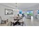 Open concept living space with dining table, chairs, kitchen bar, and living area with lanai access at 15951 Grassland Ln # 3812, Punta Gorda, FL 33982