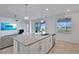 Bright, open kitchen with granite counters, stainless appliances, island, and sliding doors to outdoor patio at 15951 Grassland Ln # 3812, Punta Gorda, FL 33982