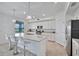 Modern kitchen with granite countertops, white cabinets, stainless steel appliances, and bar seating at 15951 Grassland Ln # 3812, Punta Gorda, FL 33982