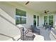 This cozy patio features comfortable seating and sliding glass doors that lead to a serene view at 15951 Grassland Ln # 3812, Punta Gorda, FL 33982