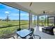 Relaxing screened-in patio offering comfortable seating and stunning views of the manicured lawn at 15951 Grassland Ln # 3812, Punta Gorda, FL 33982