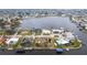An aerial view showcases a waterfront property surrounded by a canal and neighborhood homes at 168 Morgan Se Ln, Port Charlotte, FL 33952