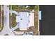 An aerial view of a house with a boat dock, patio, circular driveway, and lush landscaping at 168 Morgan Se Ln, Port Charlotte, FL 33952