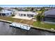 Beautiful waterfront home with a boat dock, screened-in patio, and lush landscaping at 168 Morgan Se Ln, Port Charlotte, FL 33952