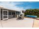 Inviting backyard with patio area, seating, and lush tropical landscaping at 168 Morgan Se Ln, Port Charlotte, FL 33952