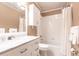 Bright bathroom features a marble vanity, toilet, shower, and coordinated cabinet at 168 Morgan Se Ln, Port Charlotte, FL 33952