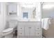 Bright bathroom with toilet, vanity with modern fixtures, and updated glass shower at 168 Morgan Se Ln, Port Charlotte, FL 33952