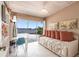 Bright bedroom with a daybed, desk, and a large sliding door overlooking the water at 168 Morgan Se Ln, Port Charlotte, FL 33952