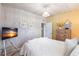 Cozy bedroom with whitewashed wood walls, a queen bed, and a view of a dresser at 168 Morgan Se Ln, Port Charlotte, FL 33952