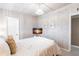 Bright bedroom features wood-paneled walls, a queen-sized bed, and a mounted television at 168 Morgan Se Ln, Port Charlotte, FL 33952