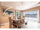 Dining room with modern wood furniture and beautiful water views from large glass sliding doors at 168 Morgan Se Ln, Port Charlotte, FL 33952