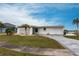 Single-story home featuring breeze block details, a winding stone driveway and a one-car garage at 168 Morgan Se Ln, Port Charlotte, FL 33952