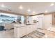 Open kitchen with an island connecting seamlessly to the inviting living room with water view at 168 Morgan Se Ln, Port Charlotte, FL 33952
