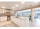 Bright kitchen with marble counters, modern appliances, island, and open to living area with water view at 168 Morgan Se Ln, Port Charlotte, FL 33952