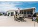 Outdoor patio with dining set, grill, and screened-in porch, perfect for entertaining at 168 Morgan Se Ln, Port Charlotte, FL 33952