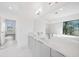 Elegant bathroom featuring a soaking tub, double vanity, and marble-style tile flooring at 17013 Alpenhorn Ct, Punta Gorda, FL 33955