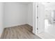 Walk-in closet featuring wood-style tile flooring and a door leading to the shower area at 17013 Alpenhorn Ct, Punta Gorda, FL 33955