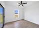 Bedroom with wood-style tile flooring, modern ceiling fan, and sliding glass doors at 17013 Alpenhorn Ct, Punta Gorda, FL 33955
