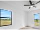Bright bedroom with large windows offering a scenic view and a modern ceiling fan at 17013 Alpenhorn Ct, Punta Gorda, FL 33955