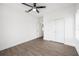 Bedroom featuring wood-style tile flooring, modern ceiling fan, and double-door closet at 17013 Alpenhorn Ct, Punta Gorda, FL 33955