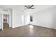 Spacious bedroom with tile floors, ceiling fan, and natural light, featuring access to a connected bathroom at 17013 Alpenhorn Ct, Punta Gorda, FL 33955